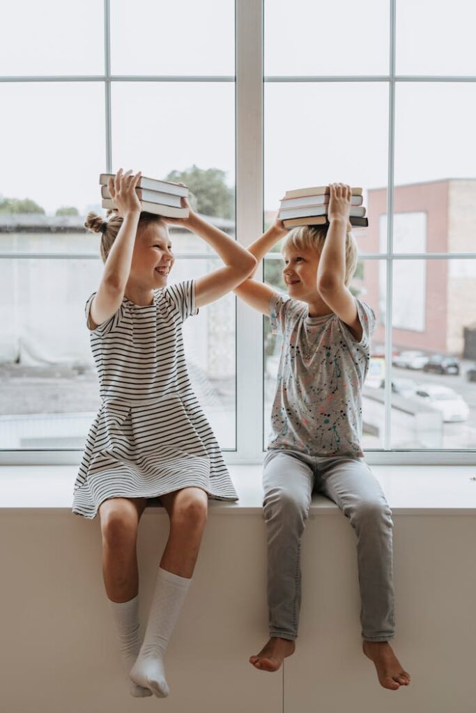 Brother and Sister With Books on Their Heads